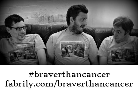 Martin (guitar), Paul (drums) and Adam (bass) on the sofa at rehearsals, wearing their #braverthancancer T-shirts.